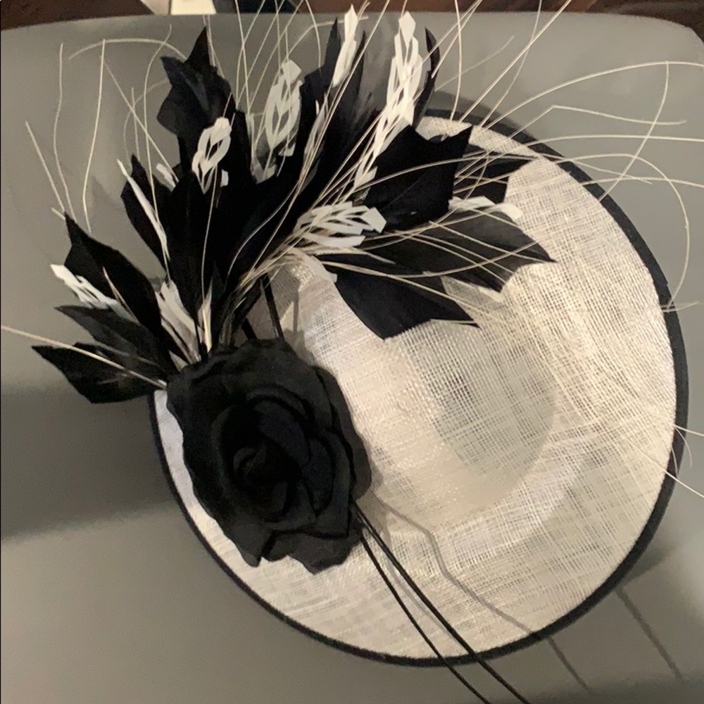 White Derby hat with black embellishments.